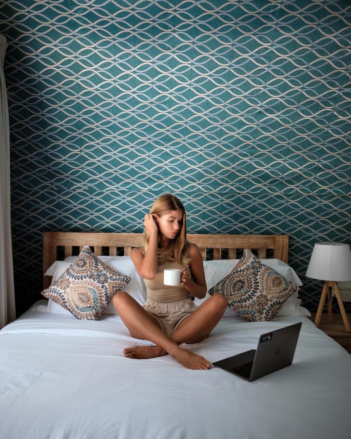 Nivadoo Resort Sigiriya Exterior photo A woman sitting on a bed